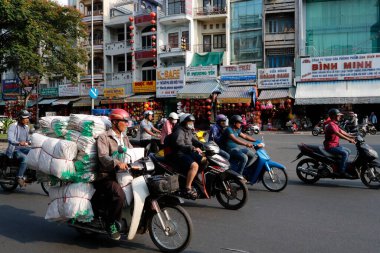 People riding motorbikes.  Road traffic.  Ho Chi Minh City. Vietnam.