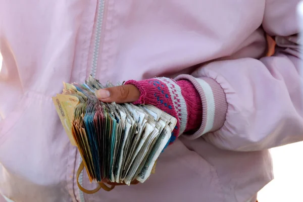 Woman at market with Vietnamese Dongs bank notes. Close-up.  Chau Doc. Vietnam.