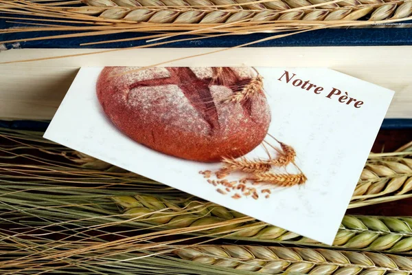 The sacred book of the Bible and ears of wheat as a symbol of spiritual and physical food.  France.