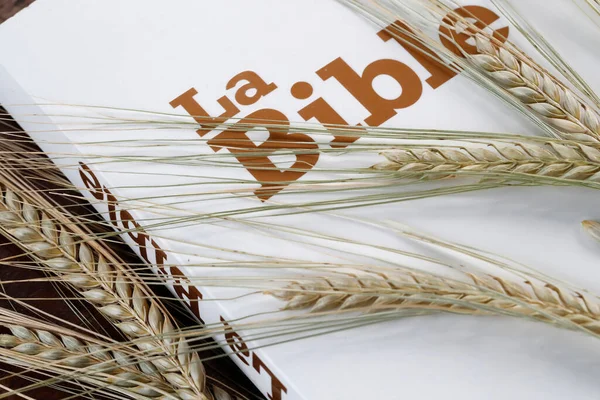 The sacred book of the Bible and ears of wheat as a symbol of spiritual and physical food.  France.