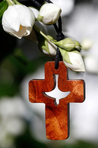 Christian cross with Holy Spirit and  white flowers.  Religious symbol.