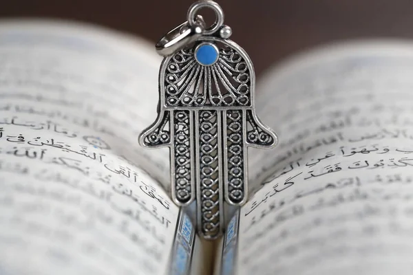 stock image Open Quran with Hamsa or Hand of Fatima.  Religious symbol. 