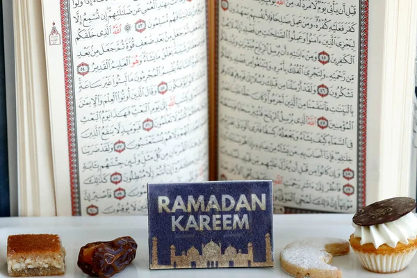 Holy Quran book with date and pastries. Ramadan concept.  Dubai. United Arab Emirates