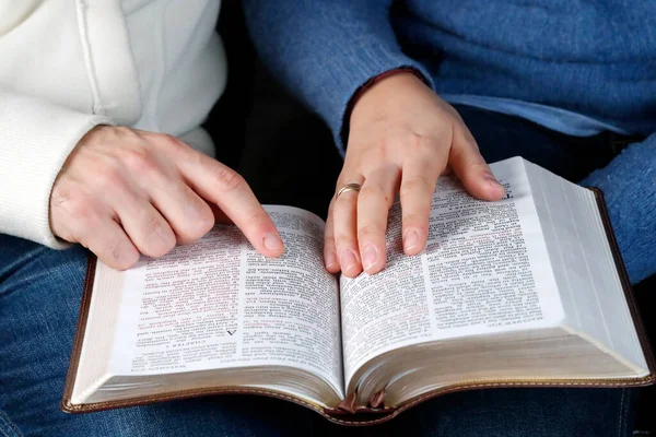 stock image Man and woman reading together the bible at home. Christian couple living in the love.    