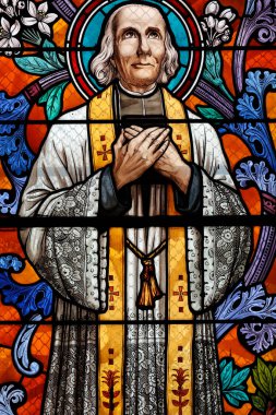 Saint Pothin church.  Stained glass window.  Saint John Vianney, was a French Catholic priest who is venerated in the Catholic Church as a saint and as the patron saint of parish priests. France.  clipart