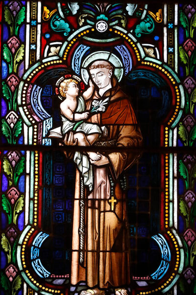 Almudena Cathedral. The crypt.  Stained glass window. Anthony of Padua with Infant Jesus in arms.  Madrid. Spain.  