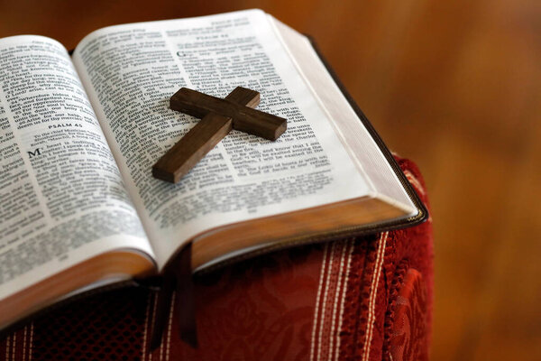 Open bible with a wooden cross.