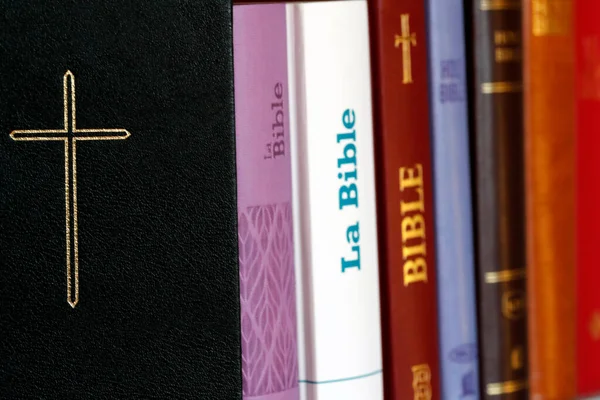 stock image Christian bibles of different versions on a bookshelf. Religious symbol. 