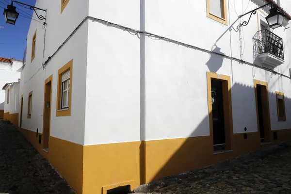 stock image Stone street by typical white and yellow houses.  Evora. Portugal. 