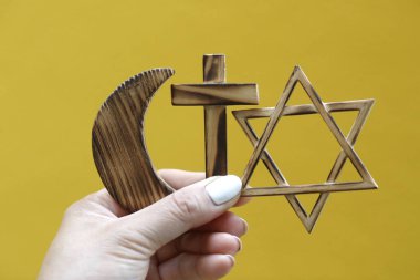 Elinde dini semboller var. Yahudi Davut Yıldızı, Müslüman yıldız ve Hilal, Hıristiyan Haçı. Din, dinler arası ve dinler arası diyalog kavramı. 