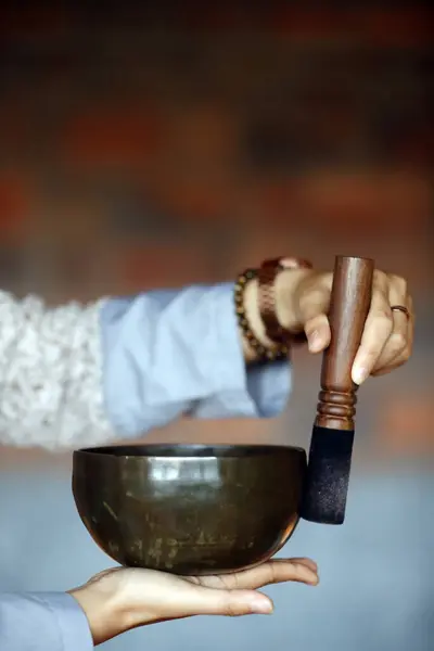 Tibetan singing bowl, buddhist instrument used in sound therapy, meditation and yoga.  Bowl in the hands of prayer.  Vietnam.