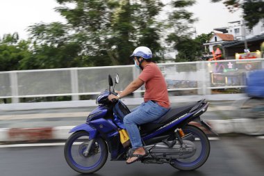 Motosiklet süren Vietnamlı bir adam. Ho Chi Minh şehri. Vietnam. 