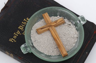 Ashes, cross and bible. Ash Wednesday celebration. Lent season.