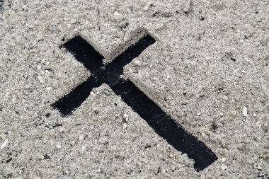 Ashes and wooden christian cross. Ash Wednesday celebration. Lent season.