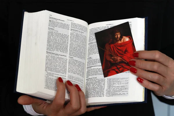 Woman with french  Bible TOB  in hands.  Faith and religion.