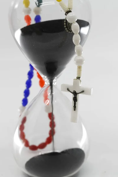Hourglass With Time Running Out and Rosary.