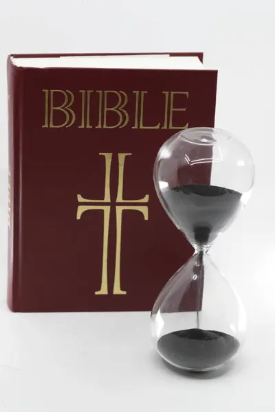 Hourglass With Time Running Out and Bible.