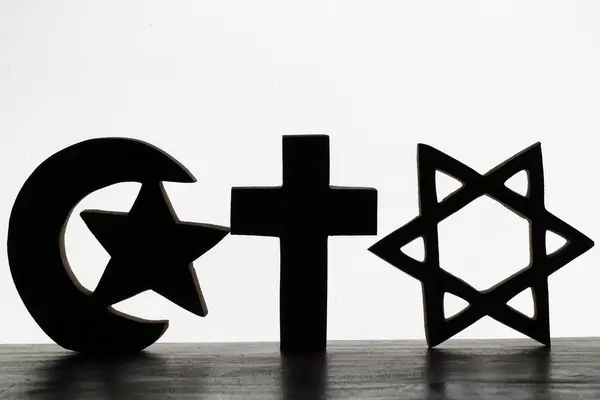Equal rights concept: Equality of religions. A jewish star of david, an islamic star and crescent symbol and a christian cross. Interfaith concept.  Religious symbols of Catholicism, Islam and Judaism. Interreligious and spirituality concept.