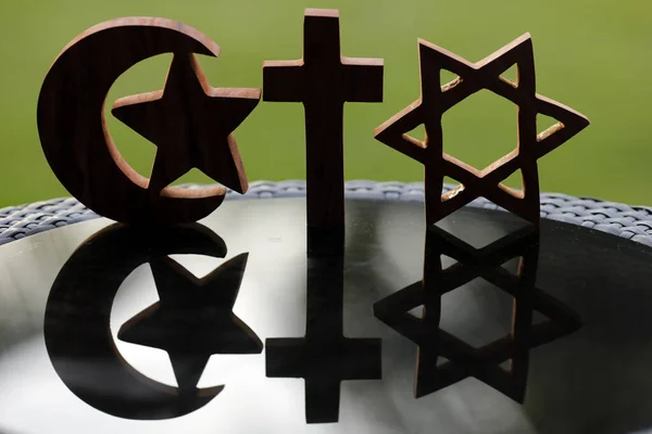 Christianity, Islam and Judaism :  the three monotheistic religions. Jewish Star, Christian Cross and Muslim Crescent : Interreligious symbols. Interfaith dialogue concept.
