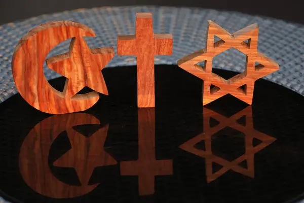 Equal rights concept: Equality of religions. A jewish star of david, an islamic star and crescent symbol and a christian cross. Interfaith relgious concept.