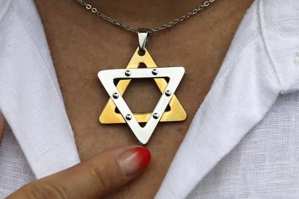 Woman wearing a Star of David  or Jewish Star pendant.