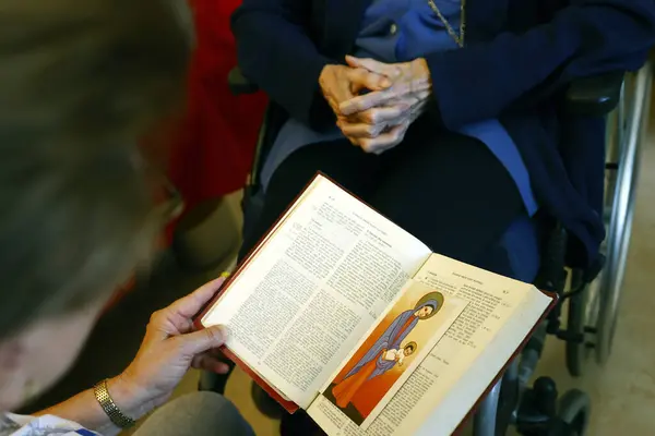 Senior woman reading the bible In retirement home.
