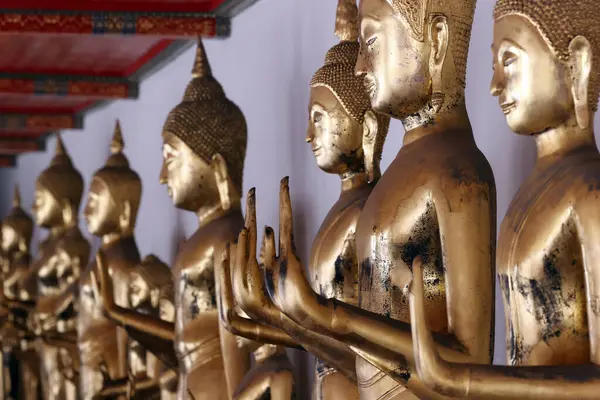 Wat Pho tapınağı. Altın Buda heykelleri sırası. Meditasyon. Bangkok 'ta. Tayland.