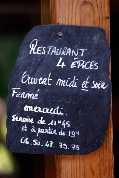 Restaurant business opening hours sign.  Saint-Gervais Mont-Blanc. France.