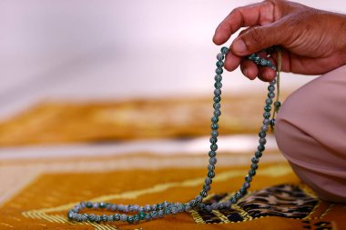 Müslüman adam tespih ile dua ediyor. Yakından çek. Vietnam. 
