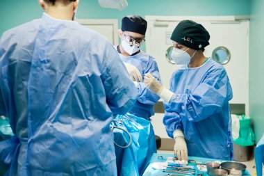 Nurse in surgical uniform passing professional instruments to anonymous male doctor in medical binoculars during surgery in hospital