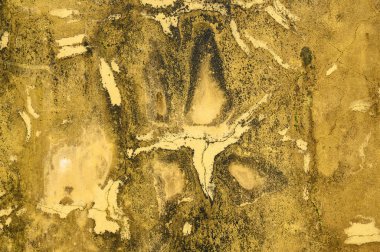 Abstract background of dirty surface of yellow color with dark spots and dots making irregular figures