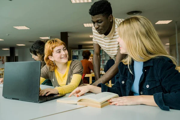 Group Young Multiracial Students Gathered Table Laptop Opened Book Discussing — Stock Photo, Image