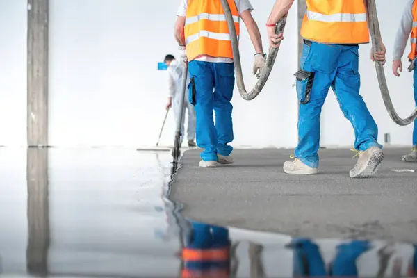 Crop Men Hose Working Team Pouring Self Leveling Concrete Floor — Stock Photo, Image