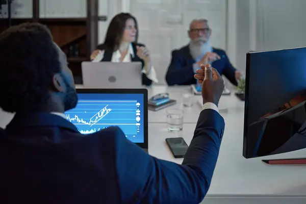 stock image A man standing in front of a computer. High quality photo