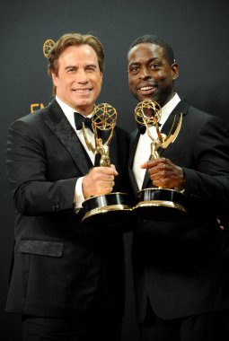 John Travolta and Sterling K. Brown at the 68th Annual Primetime Emmy Awards - Press Room held at the Microsoft Theater in Los Angeles, USA on September 18, 2016.