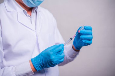 Doctor holding tube with Coronavirus vaccine and syringe. Healthcare And Medical concept.