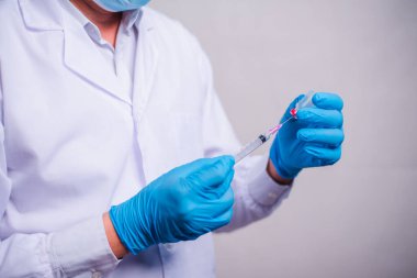 Doctor holding tube with Coronavirus vaccine and syringe. Healthcare And Medical concept.