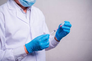 Doctor holding tube with Coronavirus vaccine and syringe. Healthcare And Medical concept.