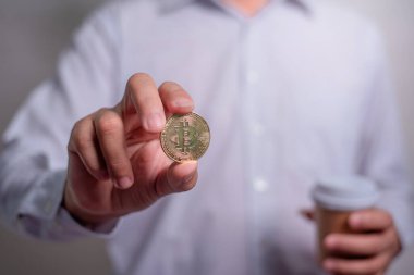 Altın Bitcoin tutan bir iş adamı. Bitcoin ile para kazanmak, dijital para birimi para yatırım konsepti, engelleme zinciri transferi.