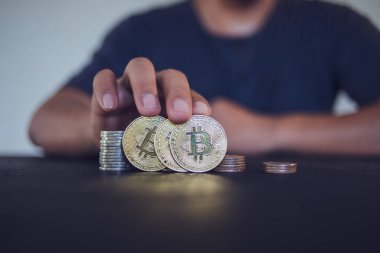 Elinde altın Bitcoin tutan bir adam. Bitcoin ile para kazanmak, dijital para birimi para yatırım konsepti, engelleme zinciri transferi.