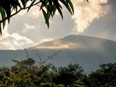 Dense clouds and mist half covering the Andean mountains at sunrise near the colonial town of Villa de Leyva in central Colombia.