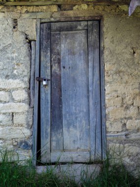 Eski bir kerpiç kulübesinin yıpranmış ahşap kapısı, Orta Kolombiya 'nın doğu And Dağları' ndaki bir çiftlikte.. 