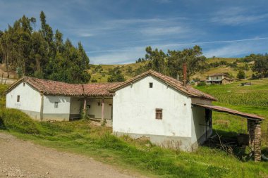 General view of an old abandoned traditional farmhouse, in the high of the mountains near the village of Cucaita, illuminated by the sunset light, in the eastern Andes of central Colombia.