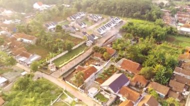 4k, Bandung 'un Cikancung bölgesindeki bir yerleşim bölgesinin kırsal görüntüsü, tepeler vadisinde yer alıyor. Drone görünümleri