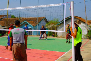 Bandung, Batı Java, Endonezya - 17 Ağustos 2023: Endonezya 'nın 78. bağımsızlık gününü anmak için orta yaşlı erkekler arasında voleybol müsabakası, eğlenceli ve ferahlatıcı bir yarışma.