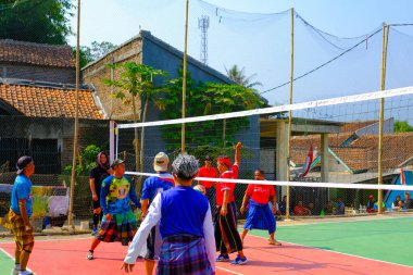 Bandung, Batı Java, Endonezya - 17 Ağustos 2023: Endonezya 'nın 78. bağımsızlık gününü anmak için orta yaşlı erkekler arasında voleybol müsabakası, eğlenceli ve ferahlatıcı bir yarışma.