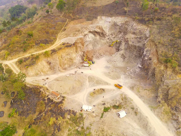 Aerial Photography. Aerial Drone view of the barren and dry landscape of Mount Pangradinan, Cikancung - Bandung, Indonesia. A barren mountain and a source of mining for local residents