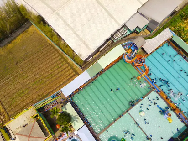 Aerial Photography. Aerial Landscapes. Top view of public water park in the middle of Bandung city - Indonesia. Cityscape urban landscape. Aerial Shot from a flying drone.