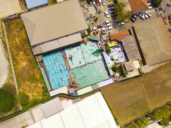 Aerial Photography. Aerial Landscapes. Top view of public water park in the middle of Bandung city - Indonesia. Cityscape urban landscape. Aerial Shot from a flying drone.
