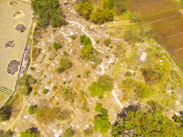 Aerial Photography. Aerial Landscapes. Top view of a public cemetery on the edge of Bandung city - Indonesia. Aerial Shot from a flying drone.